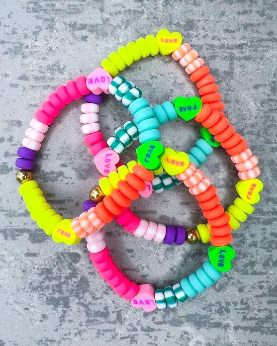 Kinder-Armband aus wunderschönen bunten und ausgesuchten Perlen! Dieses Armband ist handgearbeitet aus: kunterbunten und pastellfarbenen, matten Polymer-Scheibenperlen, Polymer-Herzen und einer goldfarbenen Edelstahlkugel.