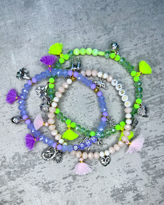 Wiesn-Halsband, Oktoberfest-Halsband, Von Hand gefertigter Schmuck für Dein Haustier.  Die Kette besteht aus beige glitzernden, facettierten Glasperlen, weißen Acrylperlen, weißen Acryl-Buchstabenperlen, osafarbenen Quasten, silberfarbenen Wiesn-Anhängern, sowie einer goldfarbenen Edelstahlkugel. 
