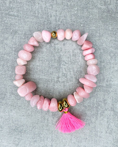 Dieses Armband ist handgearbeitet aus:
rosa gefärbten Jadeperlen, Zwischenperlen aus goldfarbenem Edelstahl, neon-pinken Quaste und einer goldfarbenen Edelstahlkugel.
