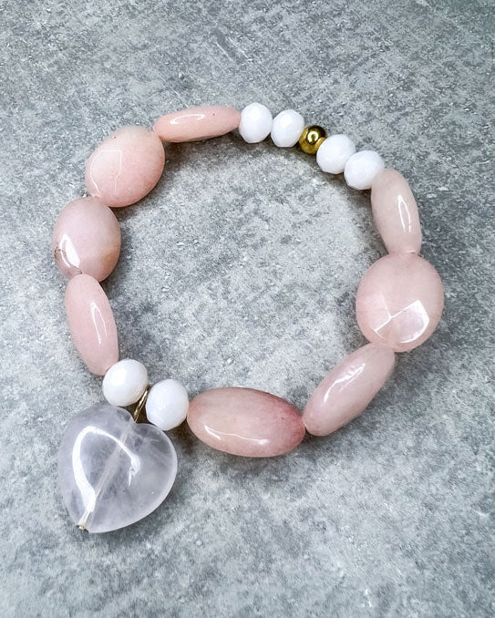 Jade- und Rosenquarz-Armband aus wunderschönen, feinen und ausgesuchten Perlen!  Dieses Armband ist handgearbeitet aus: rosé-farbenen, facettierten Jade-Edelsteinen, facettierten Glas-Perlen in der Farbe "Vanilla", einer goldfarbenen Edelstahlkugel & einem großen Rosenquarz-Anhänger in Form eines Herzens.