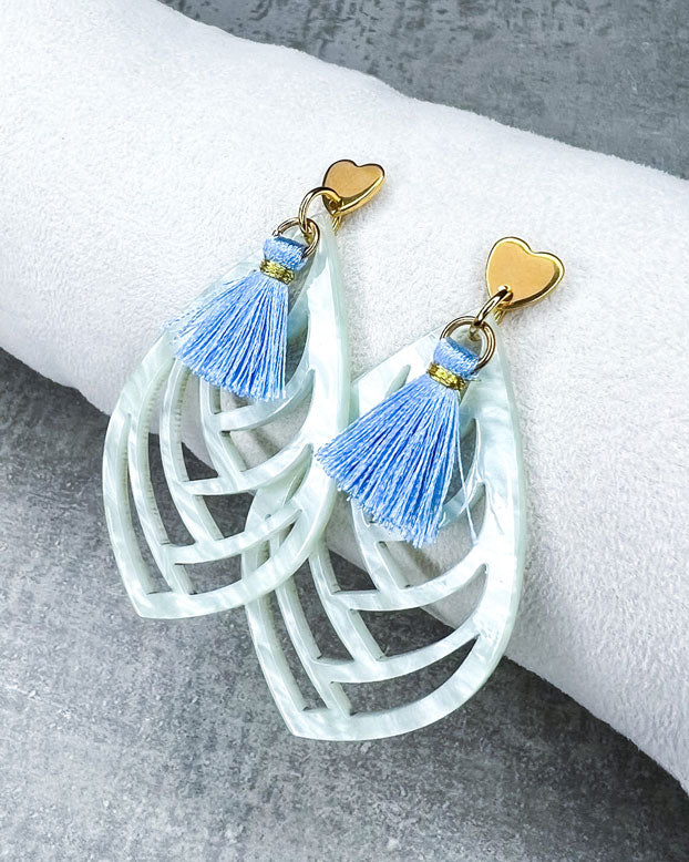 Diese Ohrringe sind gefertigt mit einem Ohrstecker aus rostfreiem Stahl in "Herz-Form", mit einem soft-türkisen Ornament-Anhänger und einer hellblauen Quaste.