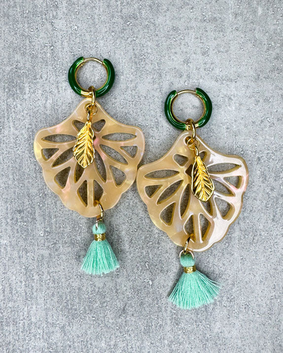 Dieser Ohrring ist gemacht mit:
einer gold- und grünen Creole, einem Ornament-Anhänger in der Farbe "Beige Glitter", einem goldfarbenen Feder-Anhänger und einer hellgrünen Quaste.
